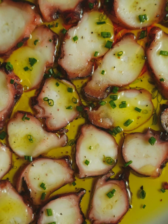 cooked vegetables cooking in sauce in a white pan