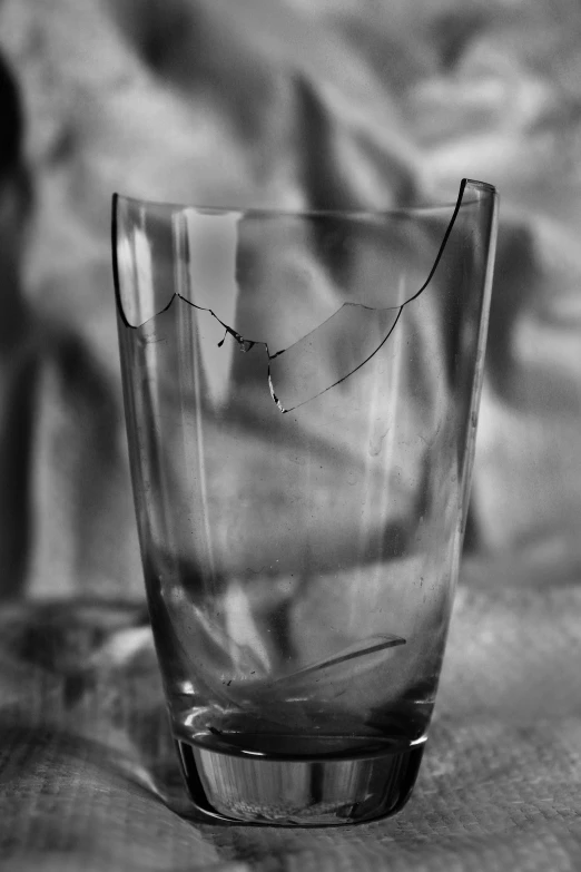 a glass cup that has been broken into pieces