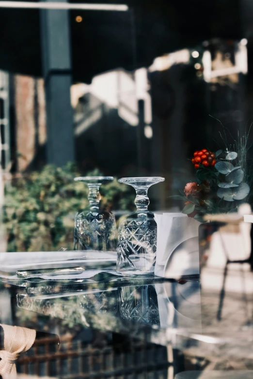 a large table with three crystal vases in the middle