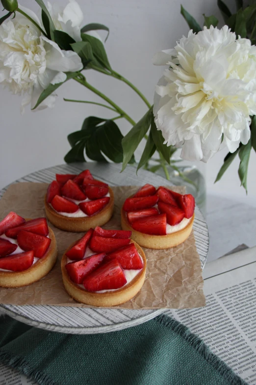 a plate topped with short desserts covered in strawberries