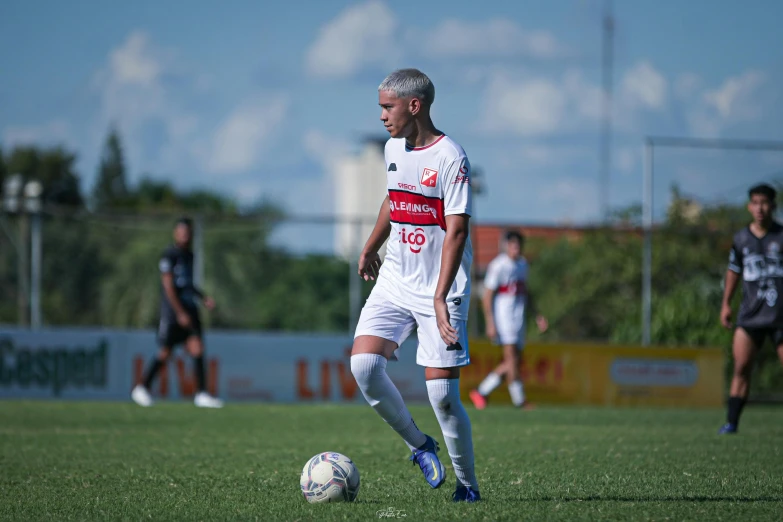 a man in a white uniform playing soccer