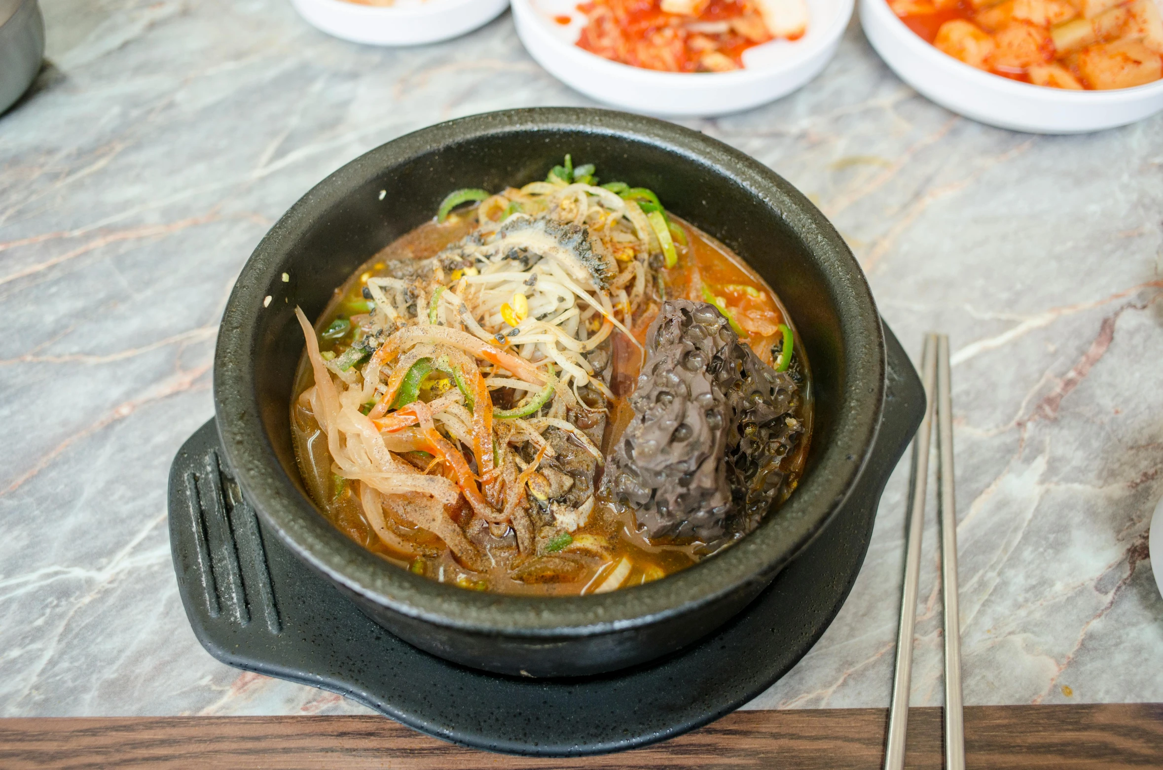 a close up of a bowl on a table with some food in it