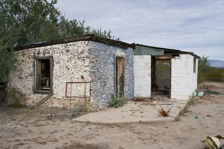 an old, run down and broken down building in the desert
