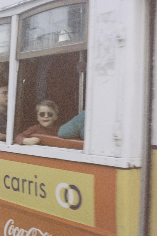 a man and woman are looking out the window of a bus