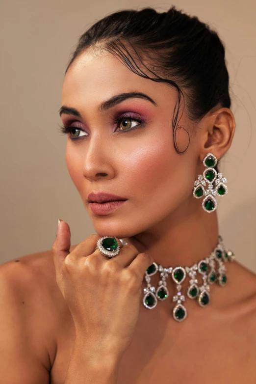 a close up po of a model wearing jewelry