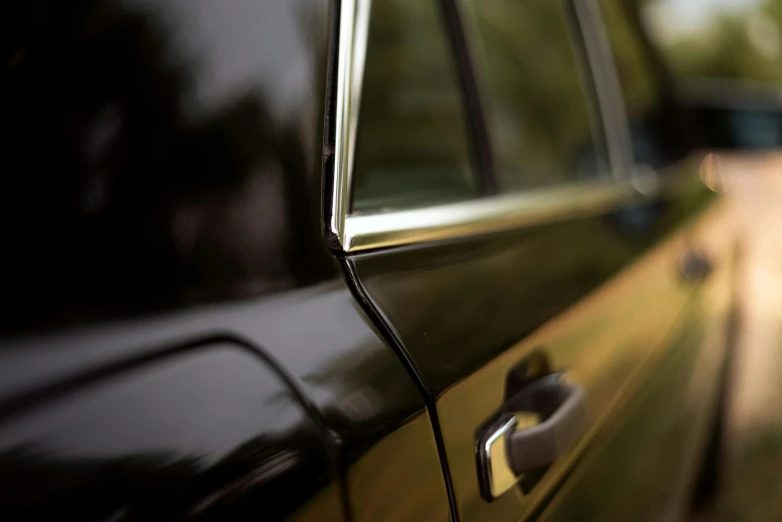 a close up view of an older car door handle