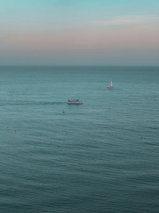 a boat and a small speedboat out in the open ocean