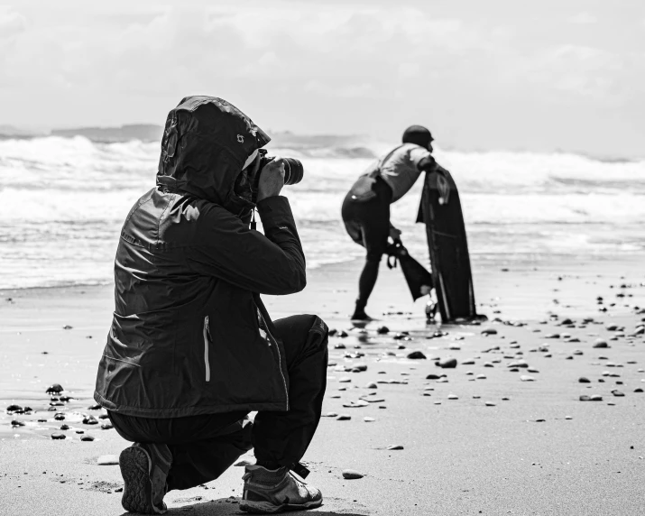 a person taking a pograph of soing off the beach