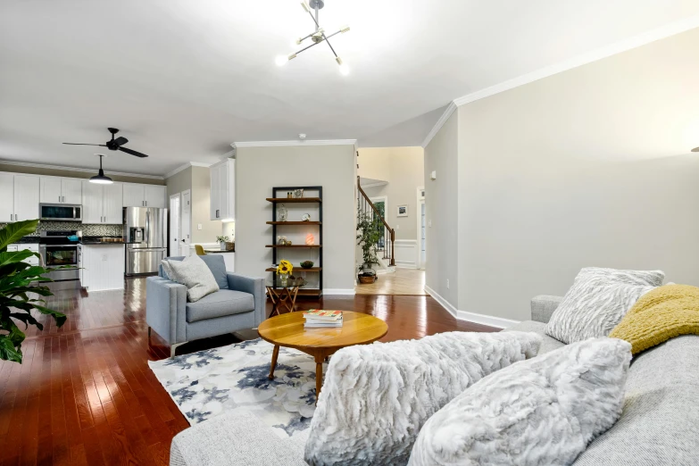 a living room with a wooden floor next to a couch and table