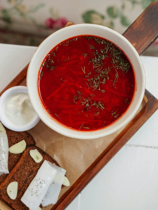 a white bowl of soup on top of bread