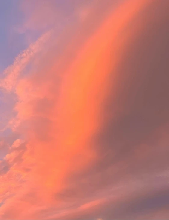 two planes are flying low over a colorful cloud