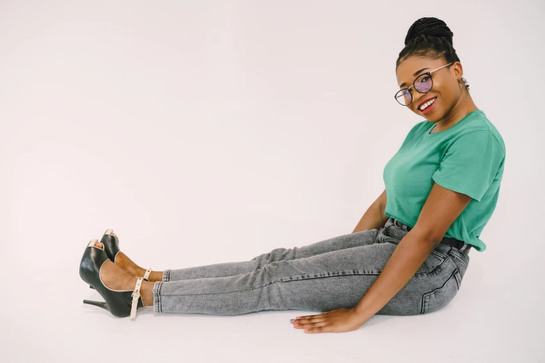 a woman wearing black high heels and green shirt