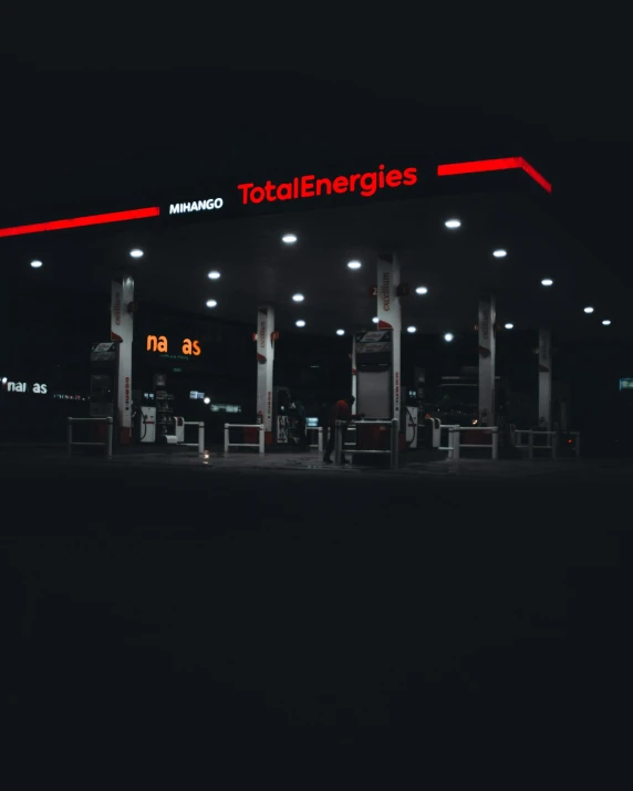 this is an image of a gas station in the dark