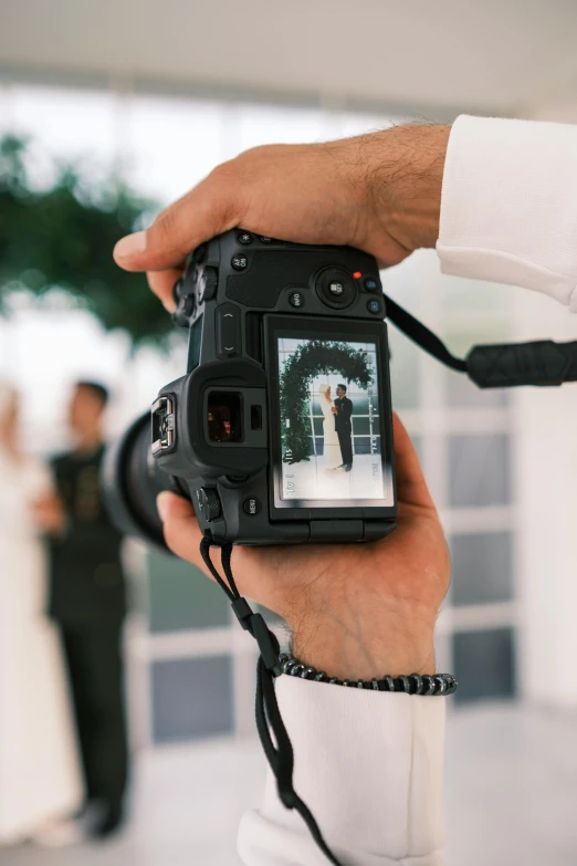 a person with a wedding dress holding up a camera