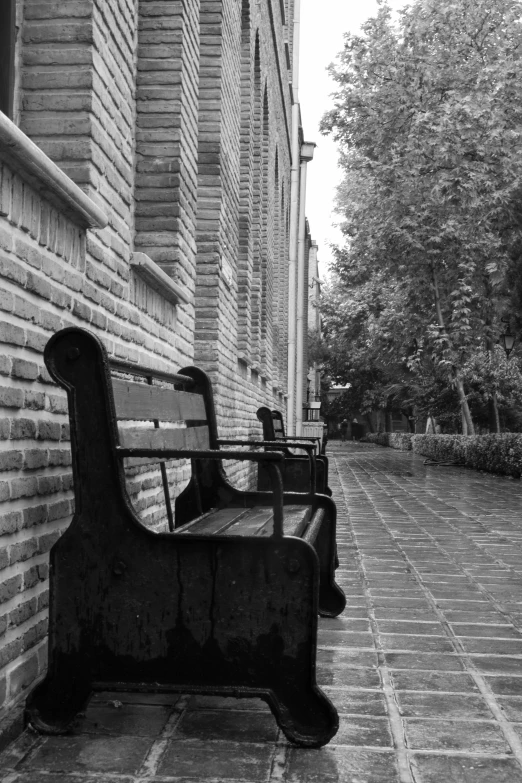 a bench sitting in front of a brick building