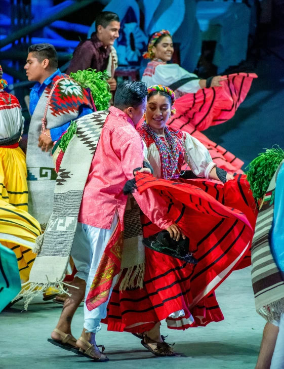 a couple of women in ethnic dress dance