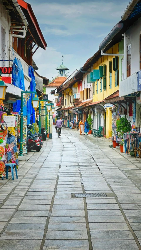 the street has many different color buildings on each side