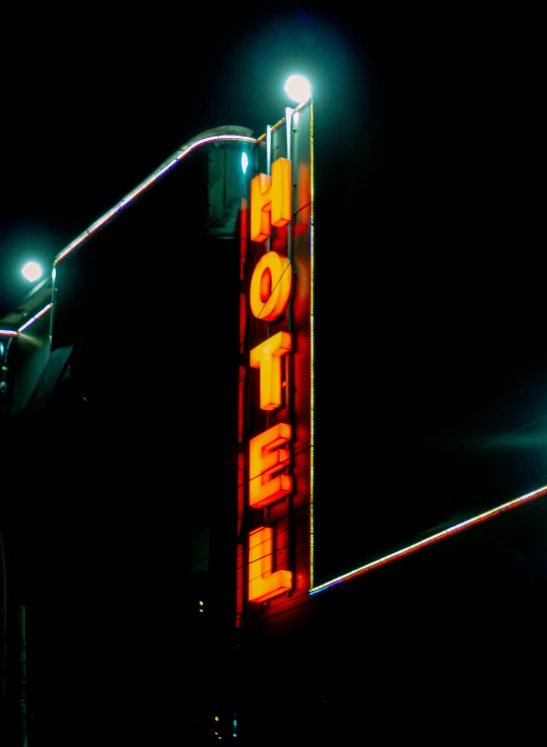 an old fashioned lighted el sign at night