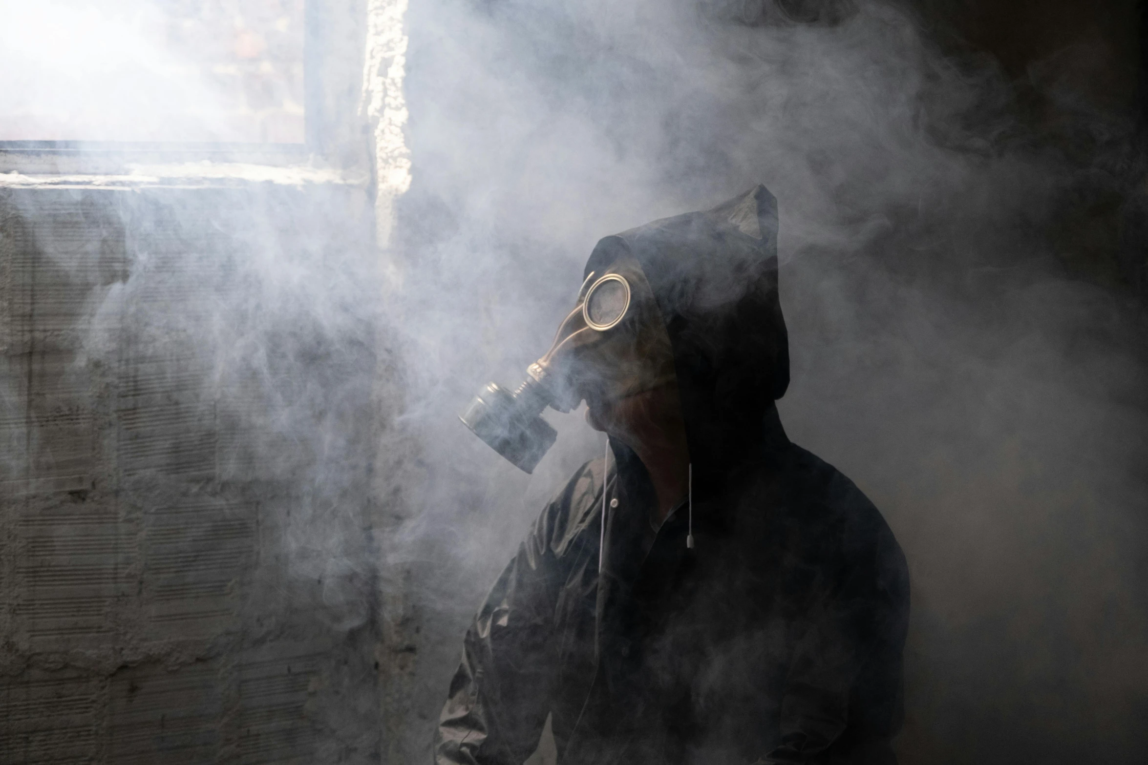 a person in a dark mask is smoking soing