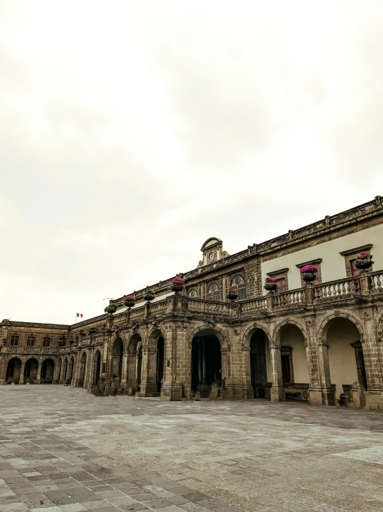 a big old building with some flags on top of it