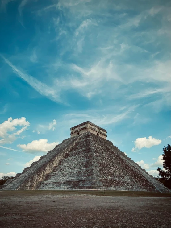 a pyramid in an arid area under a blue sky