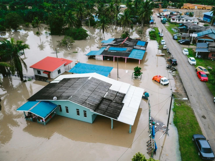 flood waters surround homes in a neighborhood