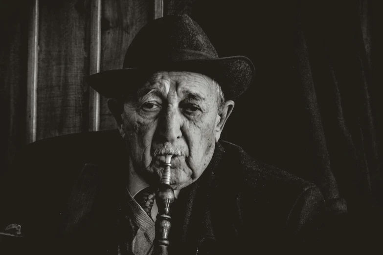 black and white po of an older man smoking a cigarette