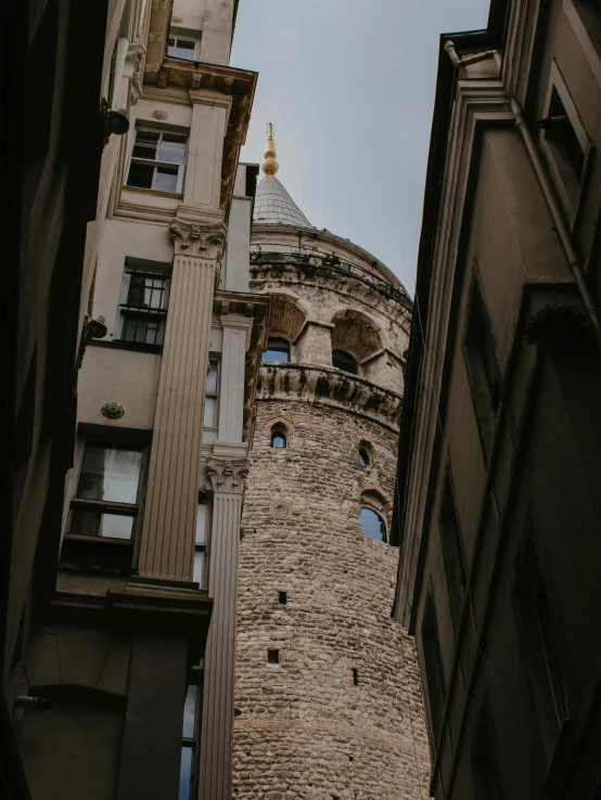 a stone castle with towers is in the middle of two other buildings