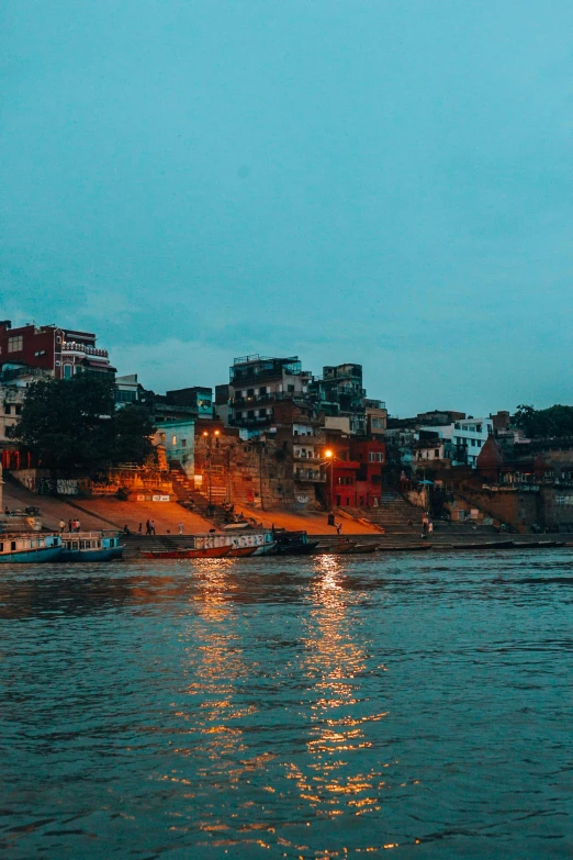 a body of water in the distance with a city lit up in it