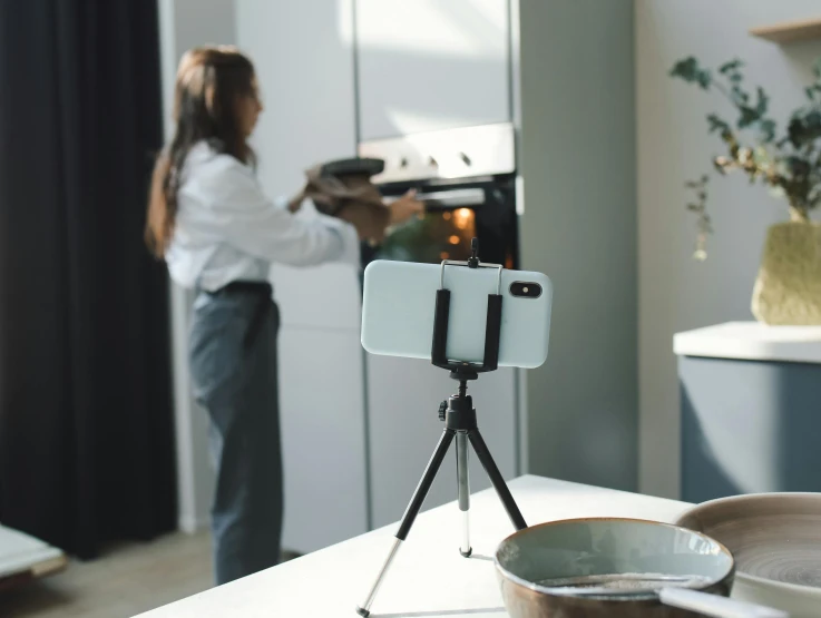 woman making food on a camera on a counter