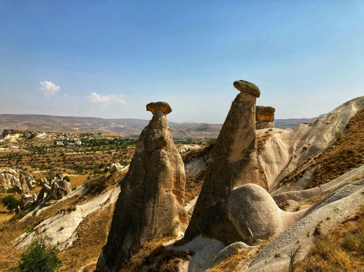 large rock formations with mountains in the background