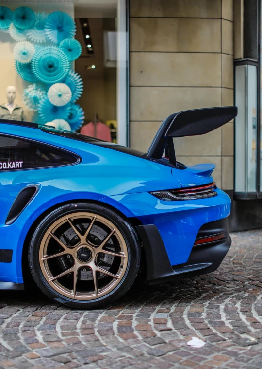 a blue sports car that is parked on some street