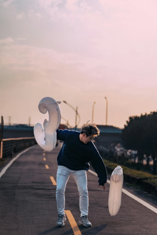 the man is skateboarding on the street outside