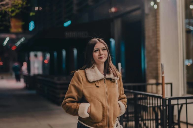 a woman standing outside of a building smiling