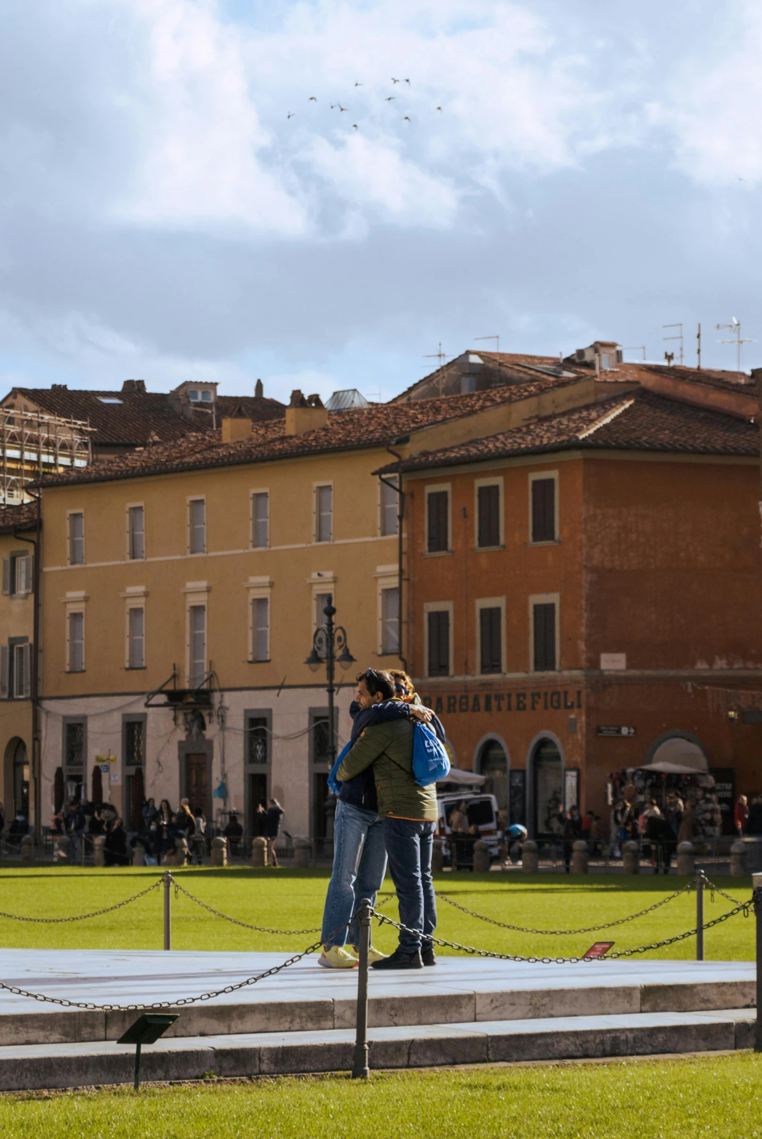 two people that are standing in the grass