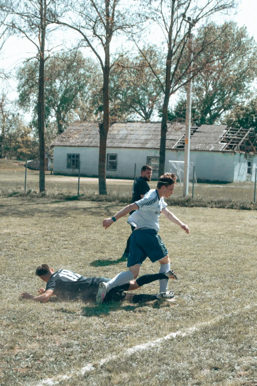 a couple of people playing a game of soccer