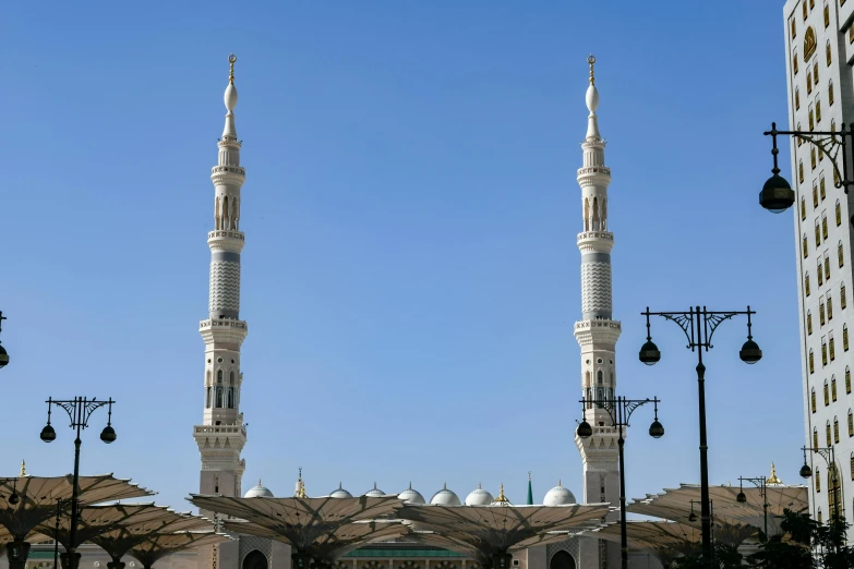 a large white building with two towers in front