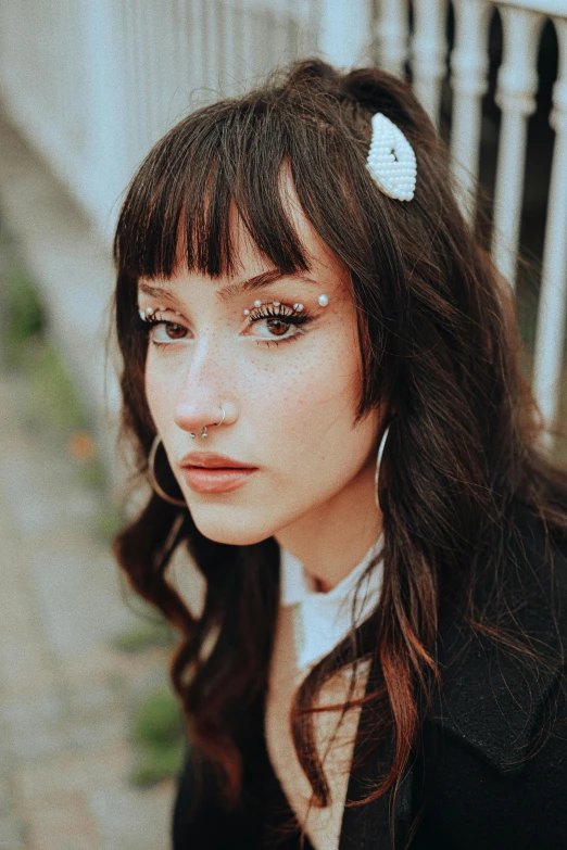 a girl with a black jacket and a white bow in her hair