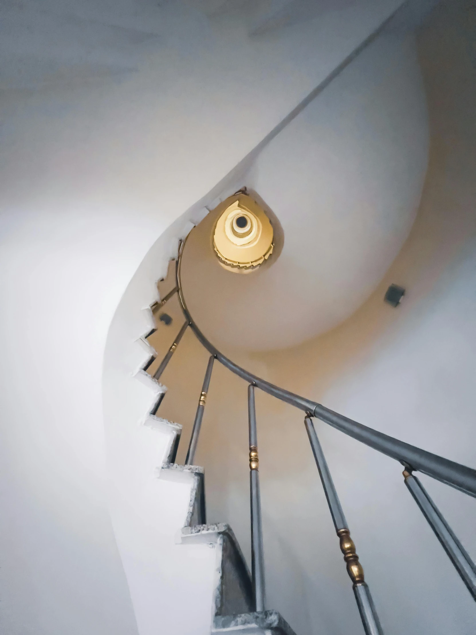 a spiral staircase with handrails and lights