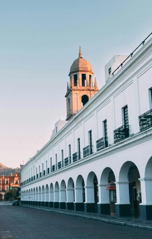 a building with white walls is in an old city