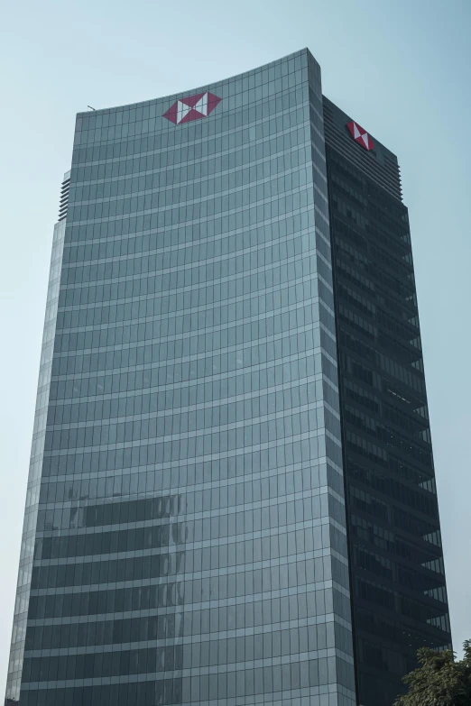 an office building is standing tall against the blue sky