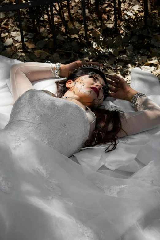 a woman with red make up and nail art lying on a pillow