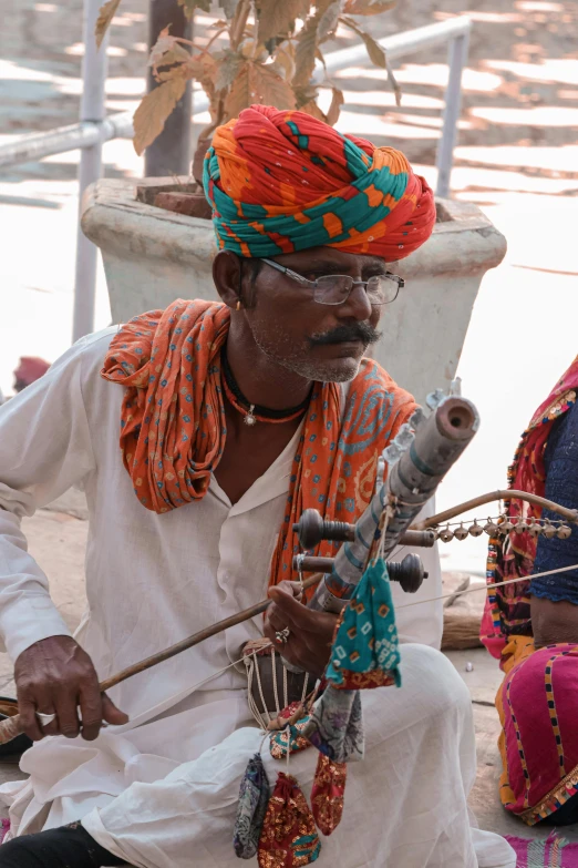 a man plays a musical instrument in the street