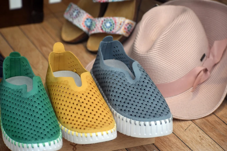 five different colored shoes and hats sitting on a table