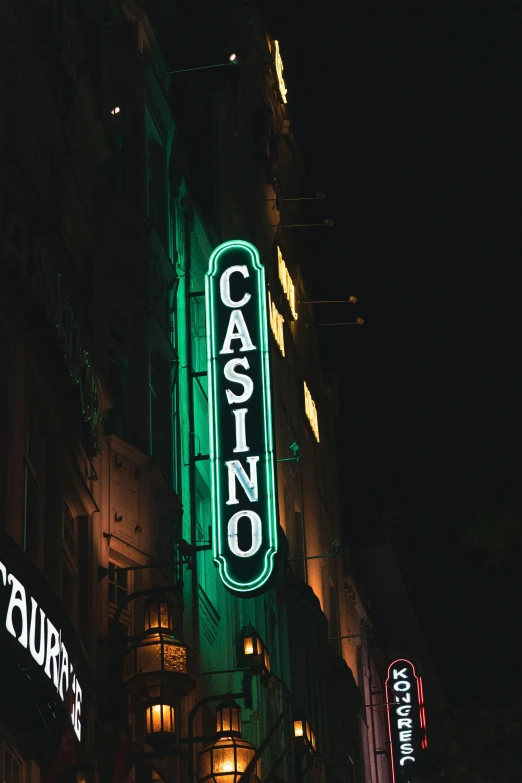 a sign for casino is lit up in the dark