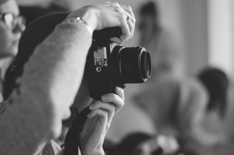 a woman is holding up a camera to take a picture