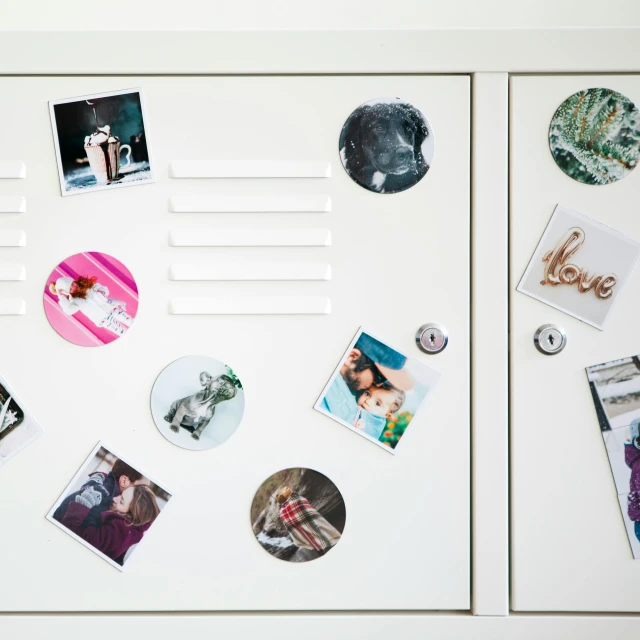 various magnets on the wall in front of a fridge