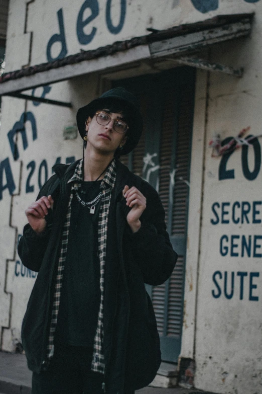 a man in glasses is standing outside of a store