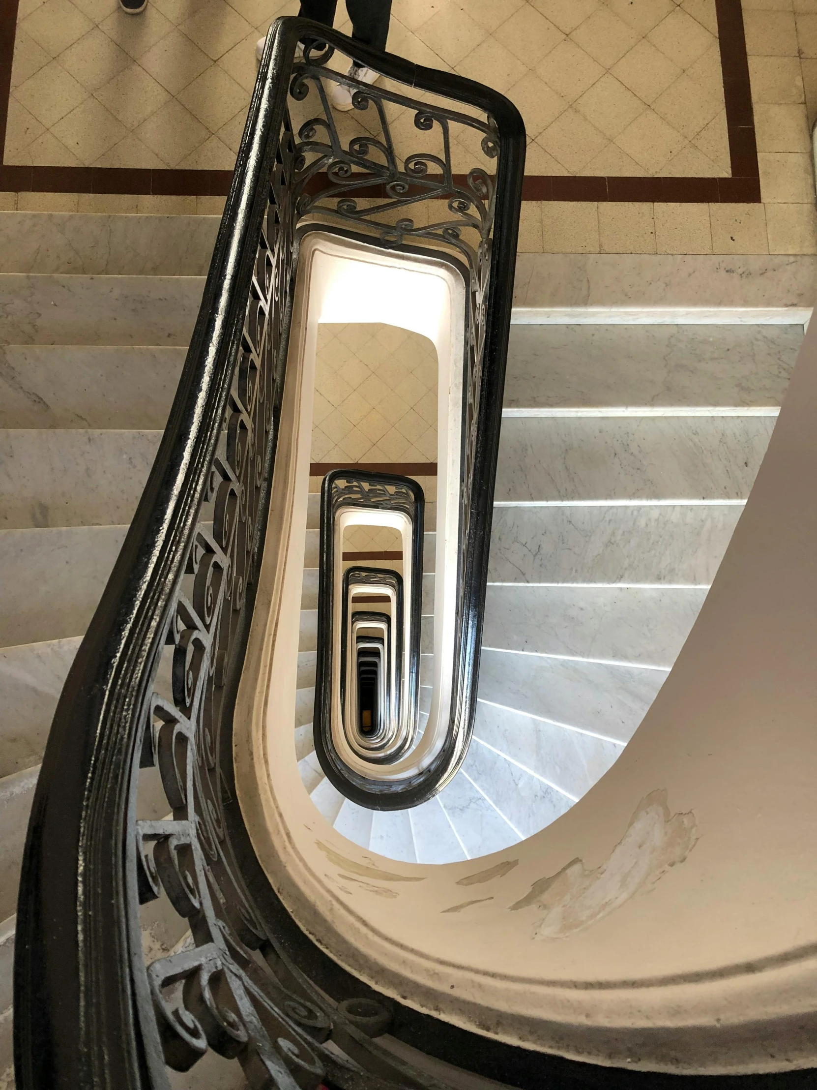 someone walking down a large marble stair case