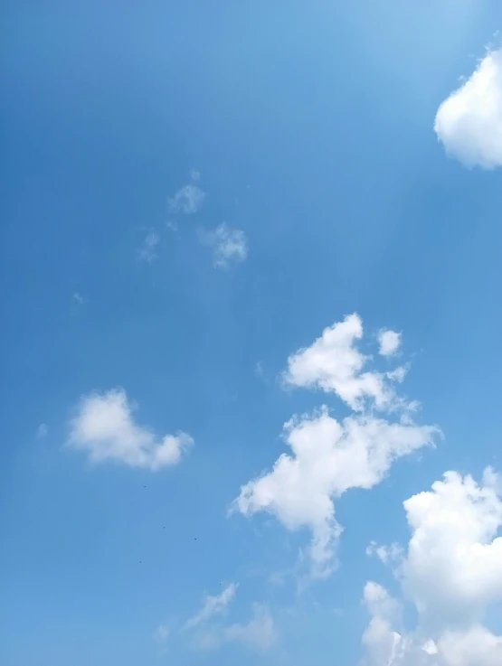 several boats are sitting in the ocean beneath a blue sky